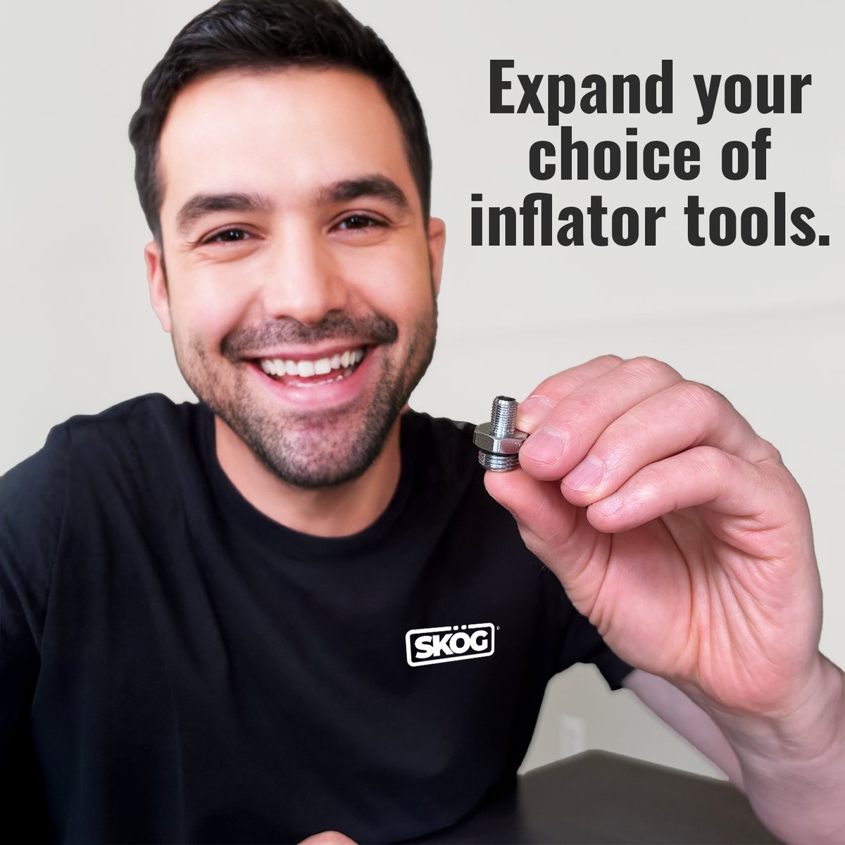 Person holding a SKÖG Adapter, expand your choice of inflator tools