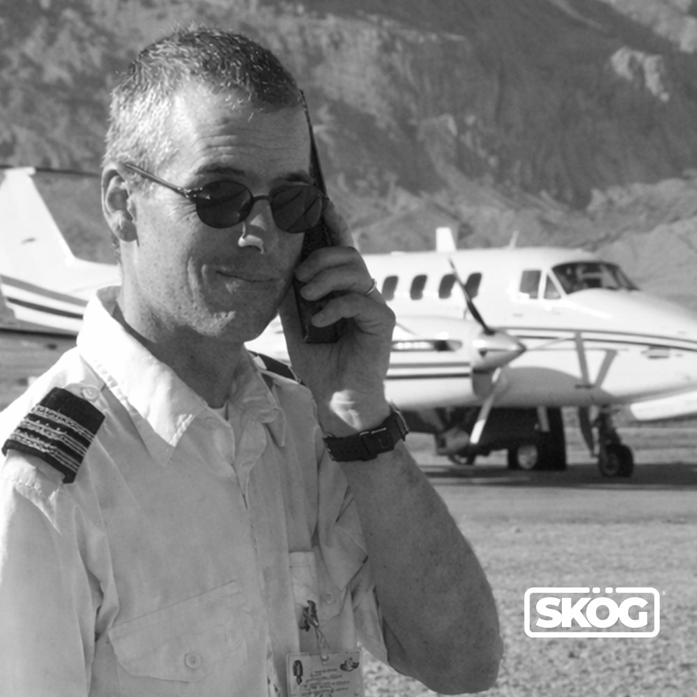 Todd Evan, founder of SKÖG® TOOLS, on the tarmac beside a King Air aircraft